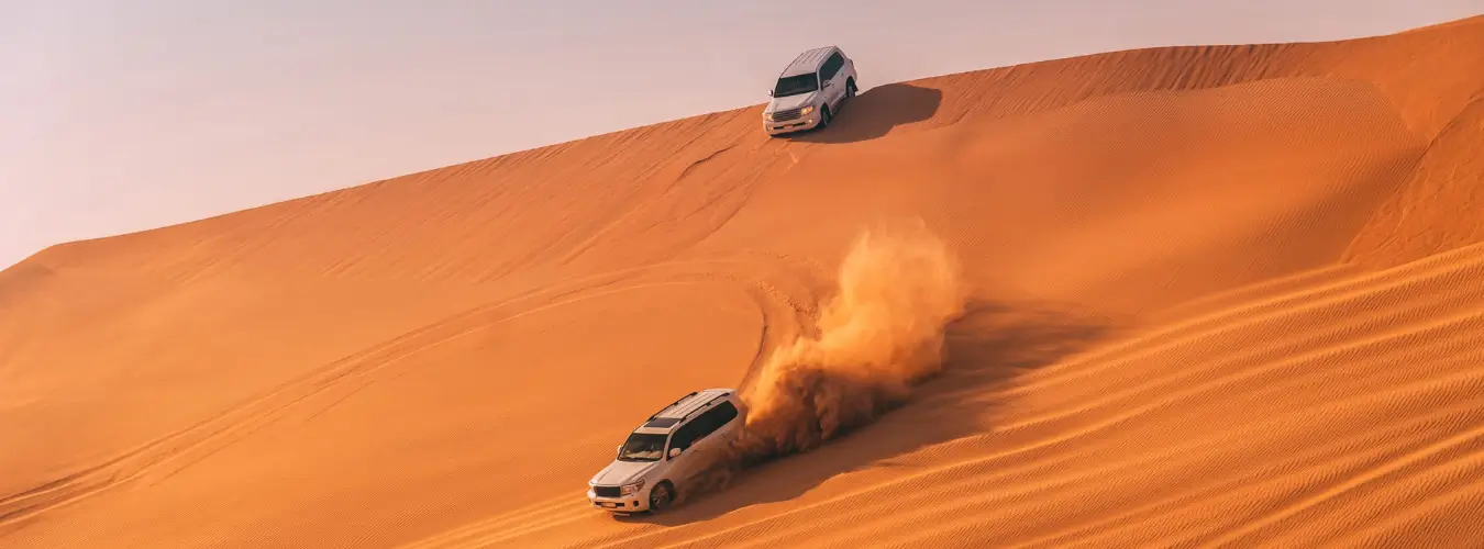 4x4 Land Cruisers dune bashing on Dubai red dunes