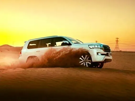 Evening desert safari in Dubai with a 4x4 on red dunes at sunset