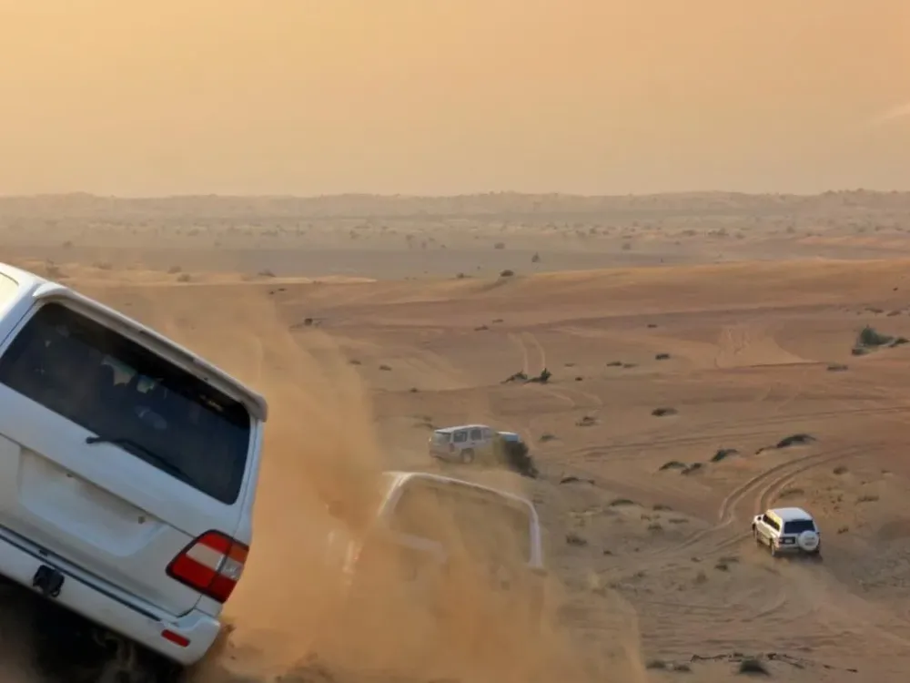 VIP red dune desert safari in Dubai with Land Cruisers on the dunes
